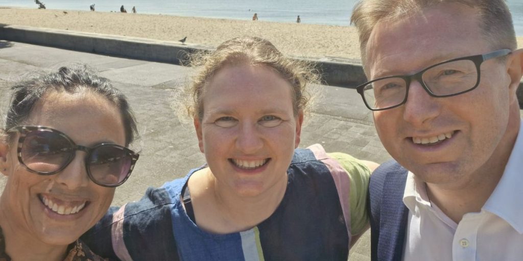 Dr Alicia Didsbury, Jane Ludemann and Professor Charlie Gourley taking a photo at the beach