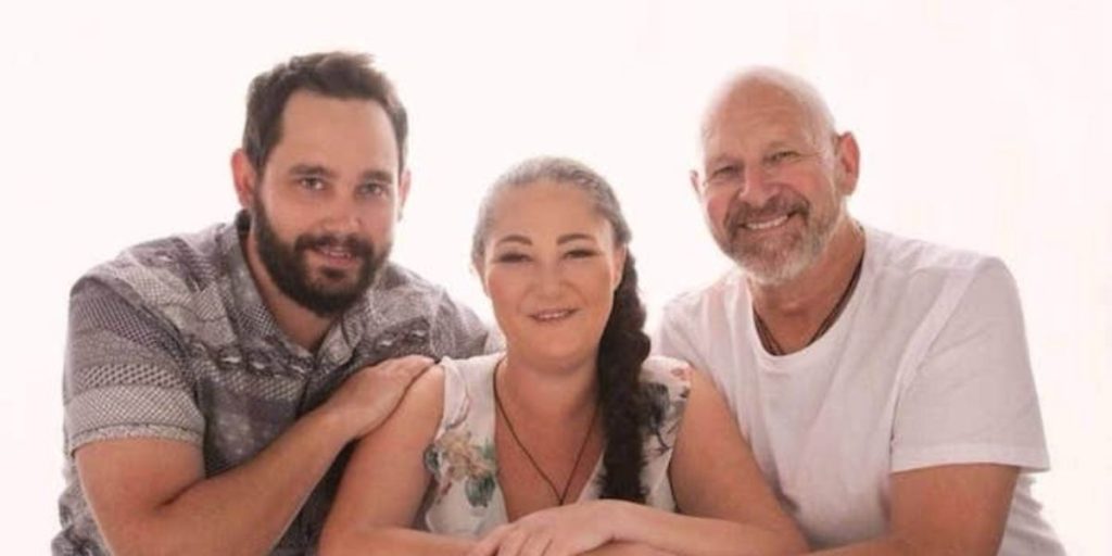 A 36 year old women sitting with her two brothers on either side of her