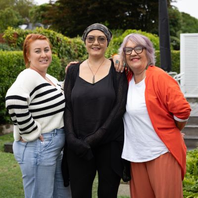 three women standing together supporting each other