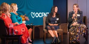 fours women taking part in a panel discussion on stage