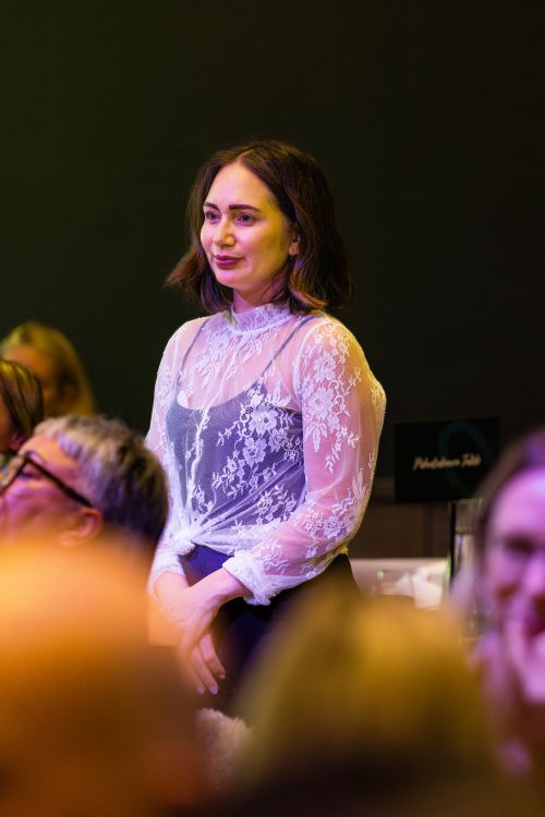 A woman standing at the event
