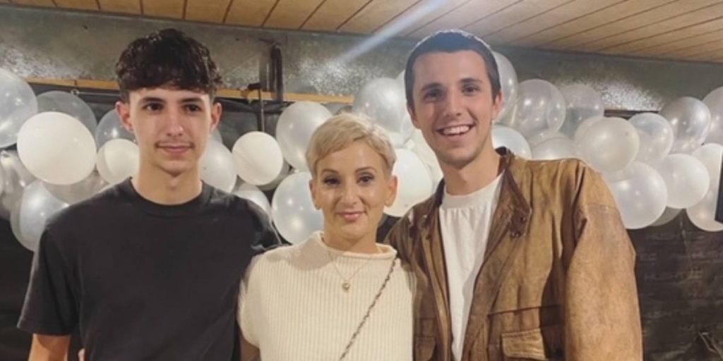 Sara standing with her two sons