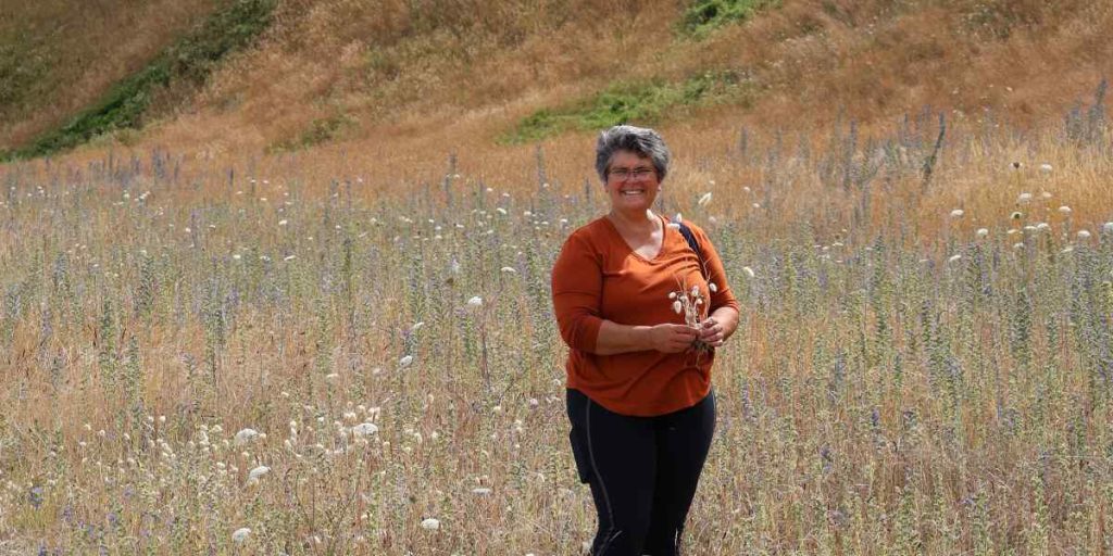 Wendy standing in a dry field