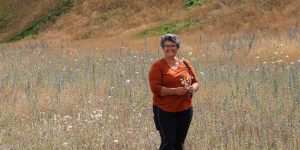 Wendy standing in a dry field