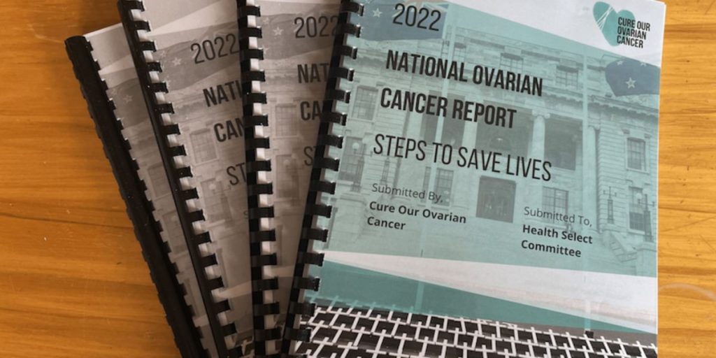 4 copies of our ovarian cancer report on a desk